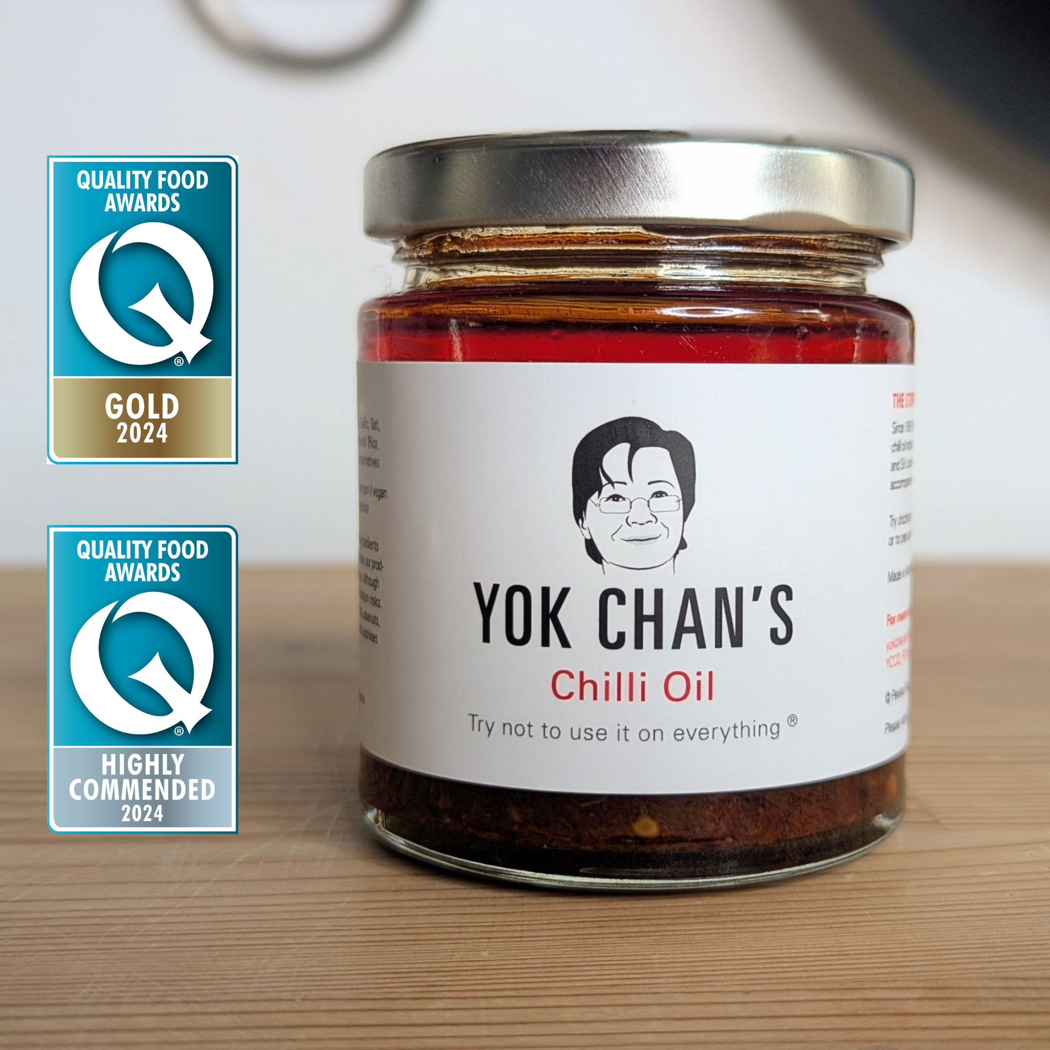 Jar of chilli oil on kitchen table with awards