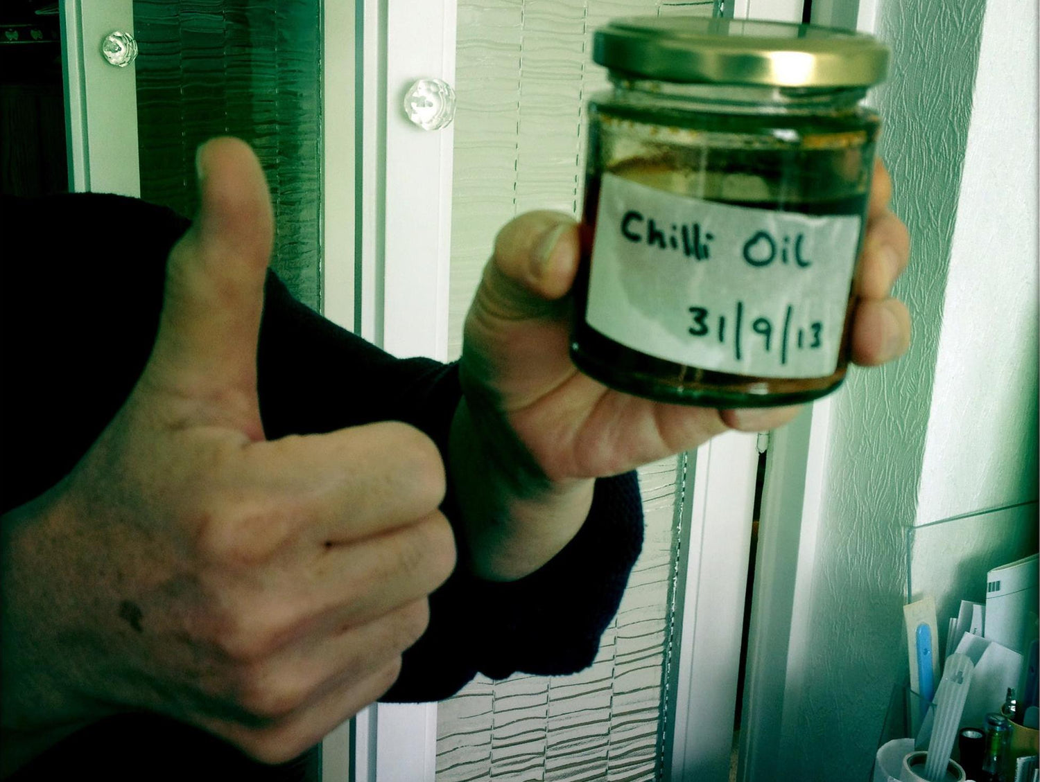 holding chilli oil jar from 2013 with filter