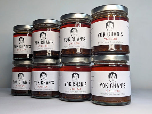 Eight jars of Yok Chan's Chilli Oil in a wall