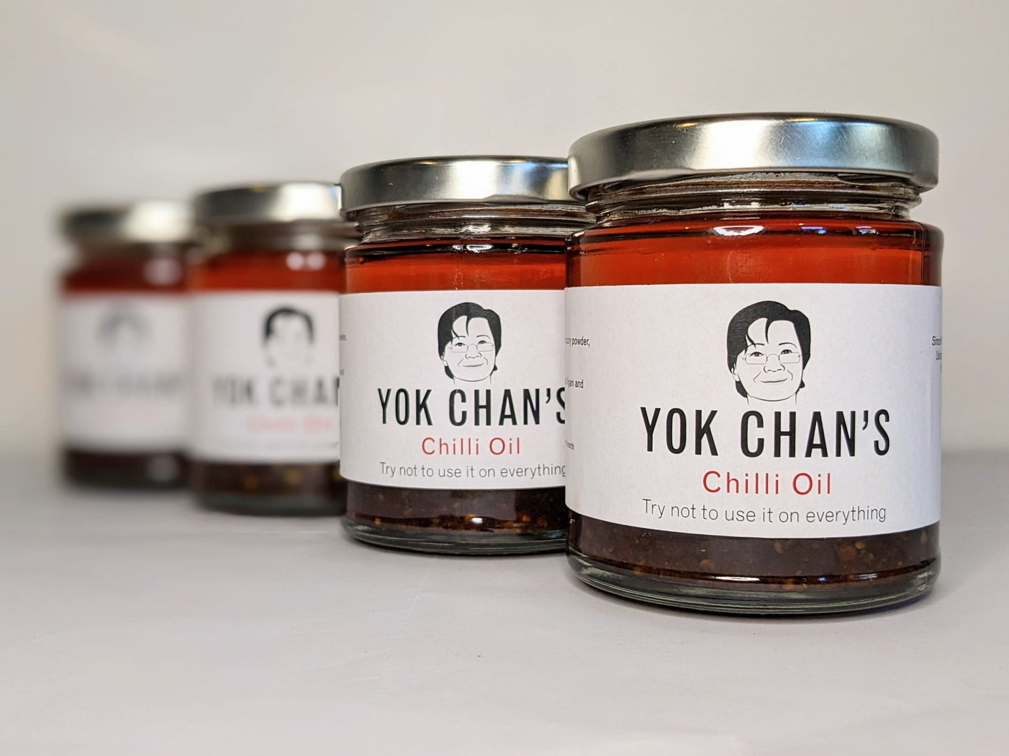 Four jars of Yok Chan's Chilli Oil right jar in focus
