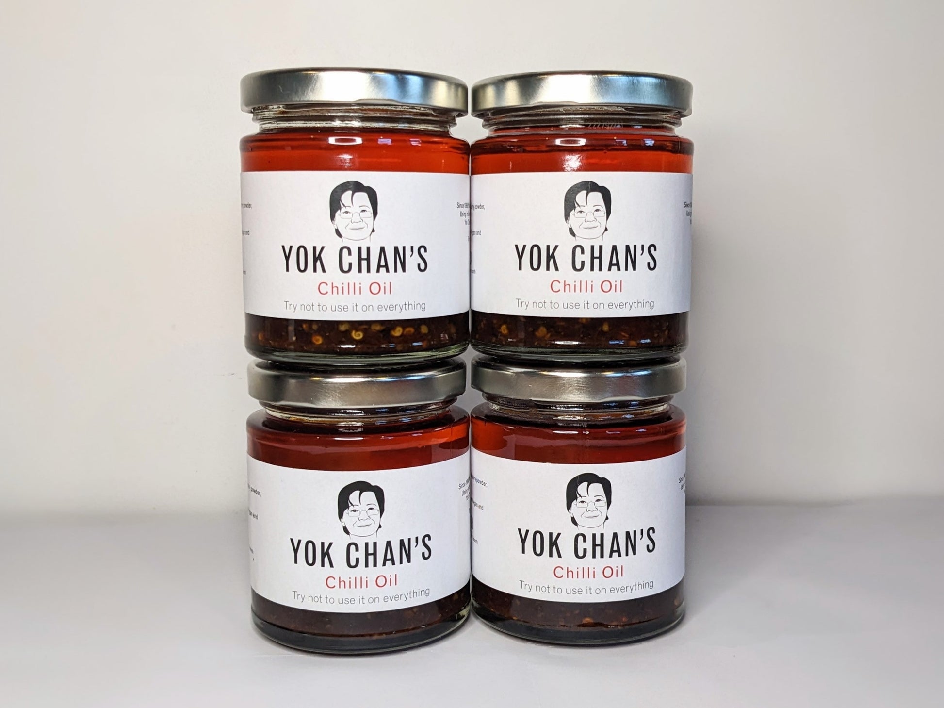 Four jars of Yok Chan's Chilli Oil stacked