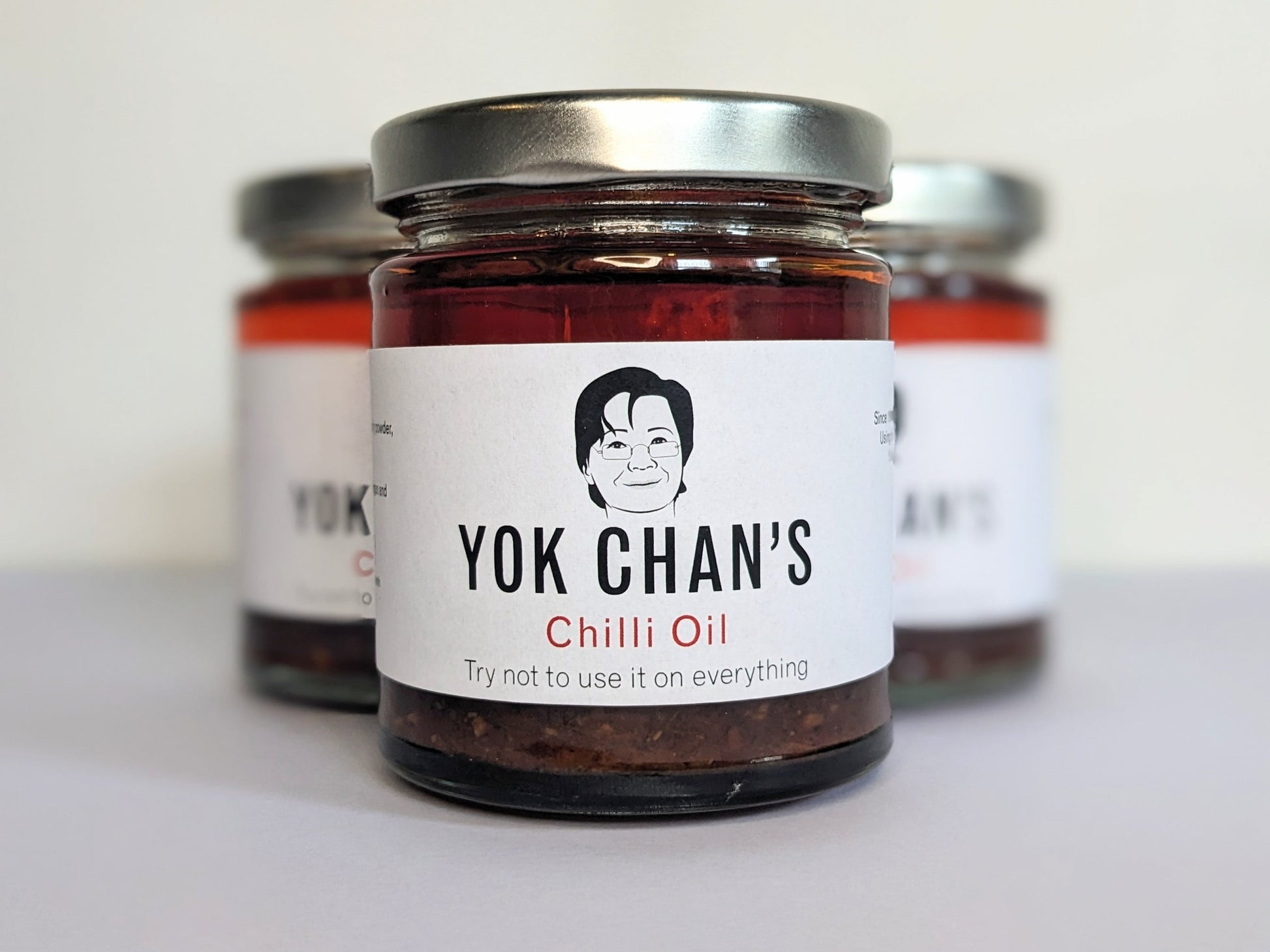 Three jars of Yok Chan's Chilli Oil in a tighter triangle